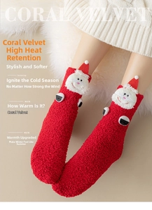 Detail of red coral fleece Christmas socks featuring a 3D Santa Claus figure on top