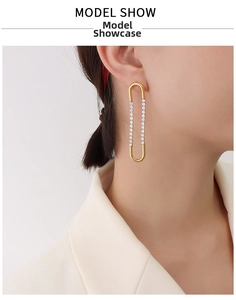 Detail of 18K gold-plated U-shaped earrings with double-row zircon inlay on a model