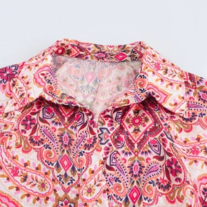 Detail of the shirt dress featuring a bohemian paisley print and a classic turndown collar