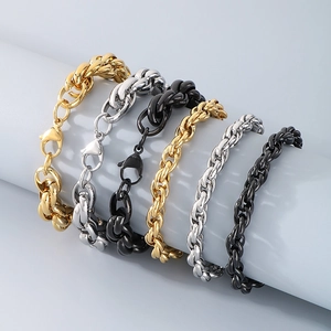 Close-up of hip hop twisted rope and cuban link bracelets in gold, silver and black steel