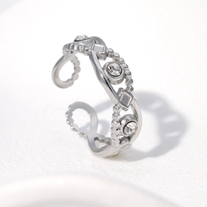 Close-up of silver wavy ring band with sparkling zircon stones and beaded texture