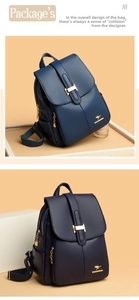 Detailed close-up of dark blue lychee-grain faux leather backpack with golden kangaroo logo