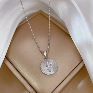Detailed macro shot of a snake pattern relief pendant in a luxury jewelry box
