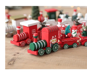 Macro detail of wooden Christmas train featuring mini snowman and Santa decor