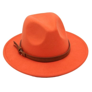 Close-up of orange wool fedora hat featuring a brown leather band and metal buckle