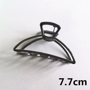 Detailed view of a 7.7cm gunmetal alloy hair claw clip with a hollow crescent design