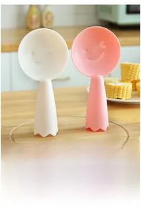 Close-up of pink and white standing rice scoops with non-stick bump texture and smiley face