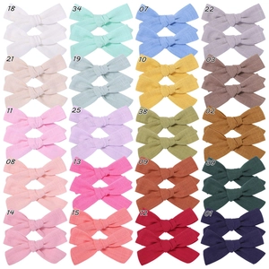 Detailed grid view of 20 assorted candy color fabric bow hair clips for girls