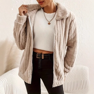 Close-up of soft beige fleece jacket featuring a zip collar and ribbed texture fabric