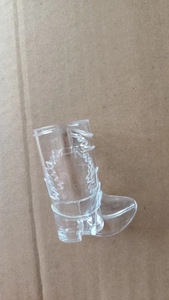Detailed top view of a transparent cowboy boot shaped shot glass for western theme parties