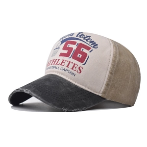 Macro detail of distressed canvas brim and vintage letter printing on a baseball cap