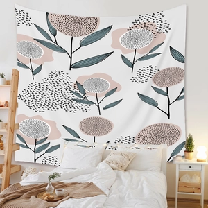 Detailed view of bohemian floral tapestry hanging above a white bed in a cozy bedroom