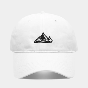 Detailed close-up of mountain peak embroidery on a white cotton baseball cap fabric