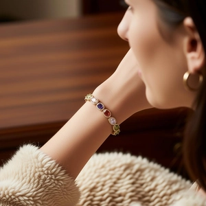 Detailed macro view of vintage gold bracelet with multi-colored oval zircon gemstones