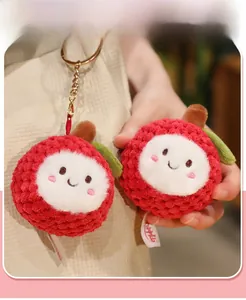 Detailed view of two plush lychee keychains with cute faces and metal rings