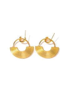 Detailed close-up of golden geometric fan-shaped earrings with fine textured lines