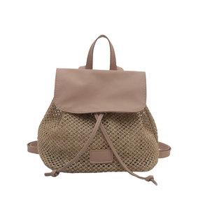 Dusty pink straw woven backpack with faux leather flap and drawstring closure for beach