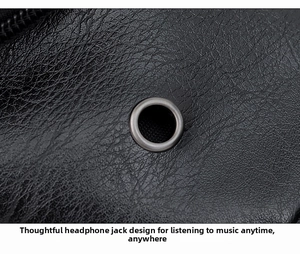 Detail of the headphone jack design and lychee texture on the black PU leather crossbody bag