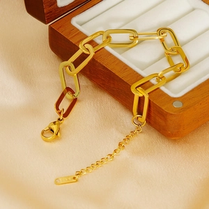 18K gold plated paperclip chain bracelet with lobster clasp and extension on wood display
