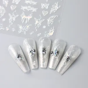 Macro shot of 3D laser silver butterfly nail stickers with Y2K style pearl accents