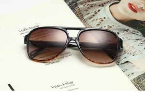 Close-up of pilot sunglasses with gradient tea lenses and tortoiseshell frame details