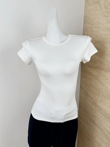 Close-up of white modal T-shirt showing fine ribbed fabric texture and slim crew neck