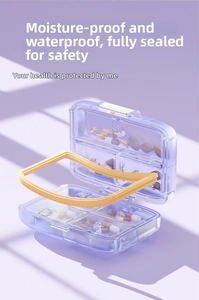 Detail view of purple weekly pill box with yellow silicone seal and multiple compartments