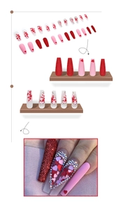 Detail of long ballerina press-on nails featuring red glitter and heart diamond accents