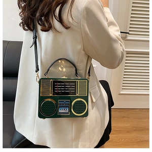 Close-up of a vintage radio style acrylic green bag with gold handle on a model