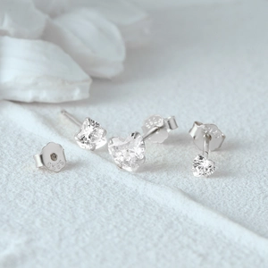 Macro detail of 925 sterling silver heart stud earrings with white cubic zirconia stones