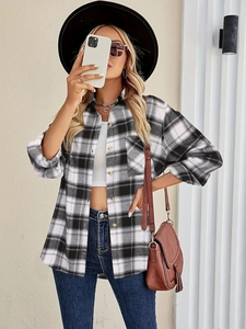 Detail of classic black and white plaid shirt with long sleeves and a chest pocket
