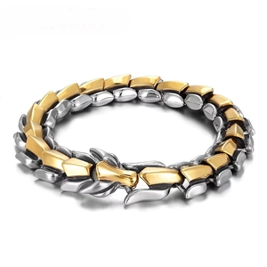 Detailed close-up of gold and silver dragon scale textured bracelet with metal clasp