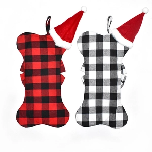 Detail of red and black buffalo plaid bone-shaped Christmas stockings with plush hats