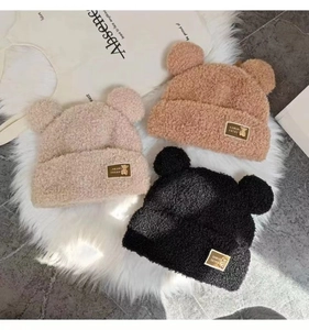 Close-up of plush teddy fleece knit beanies with bear ears in khaki, beige and black