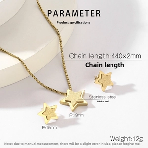 Detailed view of golden star necklace and earrings set on white geometric stands