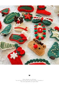 Close-up of handmade crochet Christmas hair clips with reindeer and tree designs