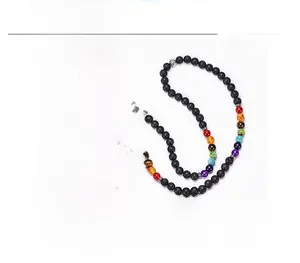 Detail of 108 lava beads necklace with chakra stones and silver tree of life pendant