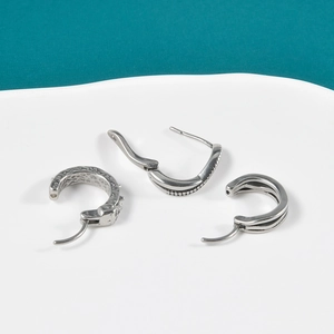 Stainless steel earrings set with hammer texture, bead edge, and polished finishes