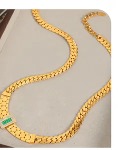 Close-up of gold Cuban chain necklace with rectangular malachite pendant and diamonds