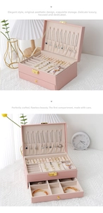 Detailed interior of a pink leather jewelry box with necklace hooks and velvet ring slots