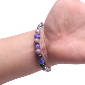 Close-up of a handmade beaded bracelet with gradient glass beads on a model's wrist