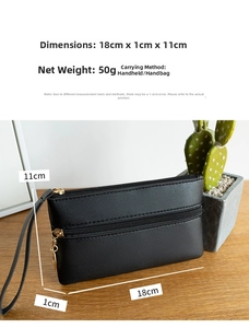 Close-up of black double-zippered PU leather clutch with wristlet and gold hardware