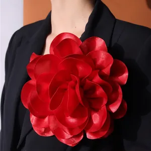 French red satin large flower brooch pinned on black blazer for fashion accessorizing