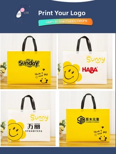 Detailed view of custom non-woven gift bags with yellow and white prints and handles