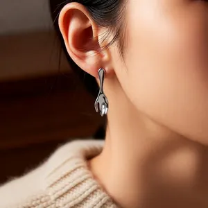 Asymmetric liquid metal lava silver earrings and necklace set for women on model