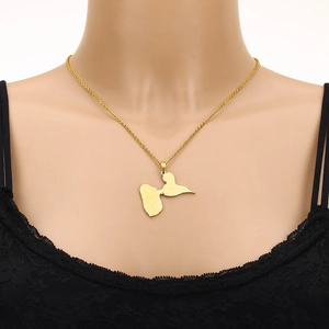 Detailed view of a gold Guadalupe map pendant on a chain worn on a black lace outfit