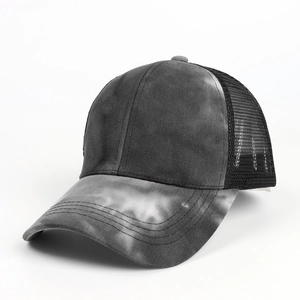 Detail of gray tie-dye fabric and black breathable mesh on the back of the baseball cap