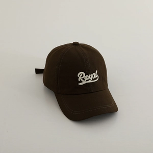 Detailed view of Royal embroidered logo on dark brown cotton baseball cap for kids