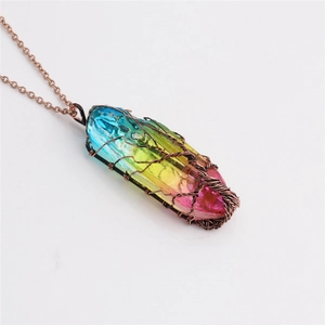Rainbow crystal column necklace with tree of life copper wire wrap on a white background