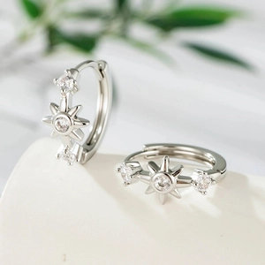 Elegant silver starburst huggie hoop earrings with sparkling crystals for a chic look